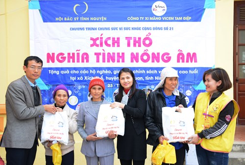 Đại diện Công ty xi măng Vicem Tam Điệp trao quà tặng hộ nghèo.