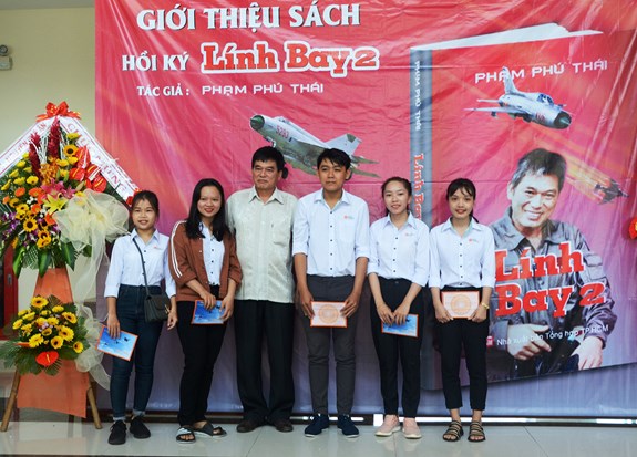 Tác giả chụp hình lưu niệm cùng bạn đọc tại buổi giới thiệu sách.