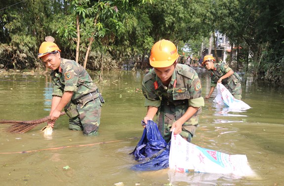 Thu dọn rác trên các ngõ, xóm bị ngập.