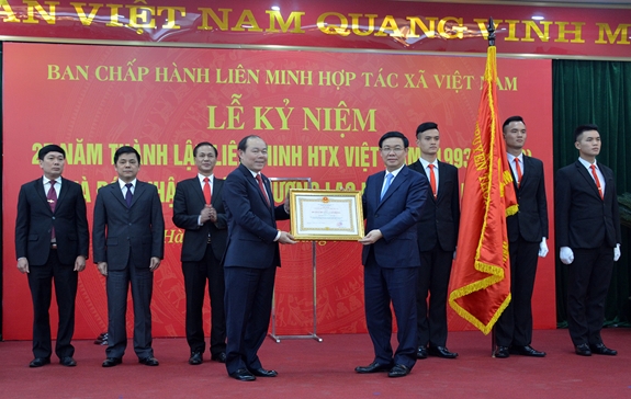 Thừa ủy quyền của Chủ tịch nước, Phó thủ tướng Vương Đình Huệ trao Huân chương Lao động hạng Nhất cho Liên minh HTX Việt Nam.