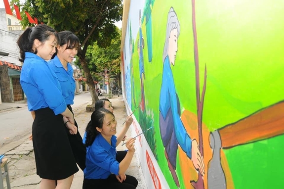 Đoàn viên thanh niên phường Văn Đẩu tham gia vẽ tranh tường trên đường Hương Sơn.