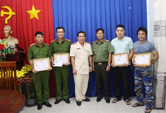 Đại tá Đinh Văn Nơi, Giám đốc Công an tỉnh và Đại tá Nguyễn Nhật Trường, Phó giám đốc Công an tỉnh trao giấy khen và thưởng nóng cho cán bộ và người dân dũng cảm bắt cướp.